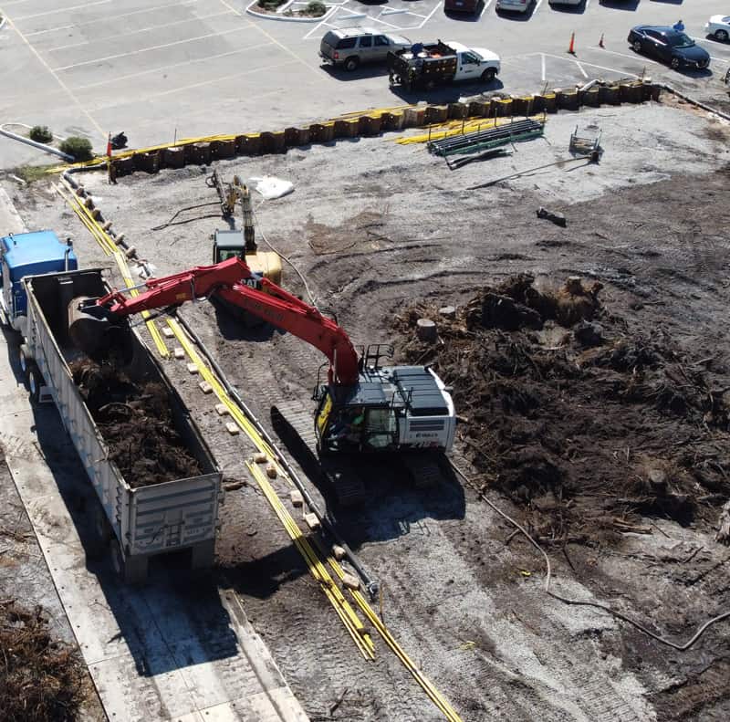 Site remediation featuring excavator and end dump trailer