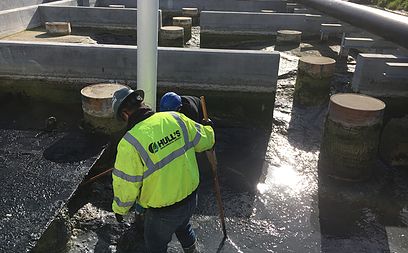 Digester sludge byproduct vacuum removed and disposed of