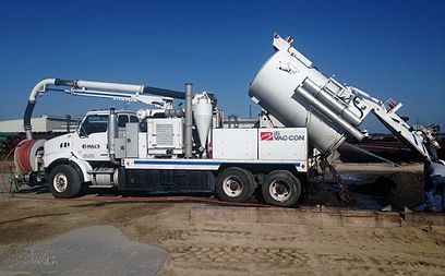 Vacuum combination trucking dumping a load